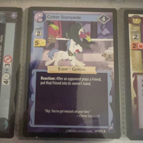 Photograph of a My Little Pony trading card 'Critter Stampede' with the quote 'Hey, you got weasels on your face' attributed to Cheese Sandwich.